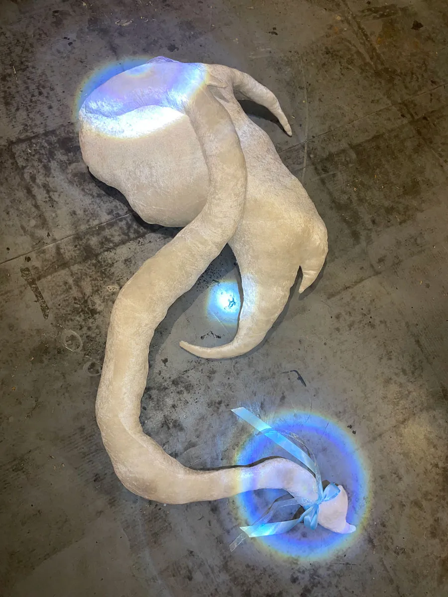 Cetus creature shown resting on couch, displaying its protective presence