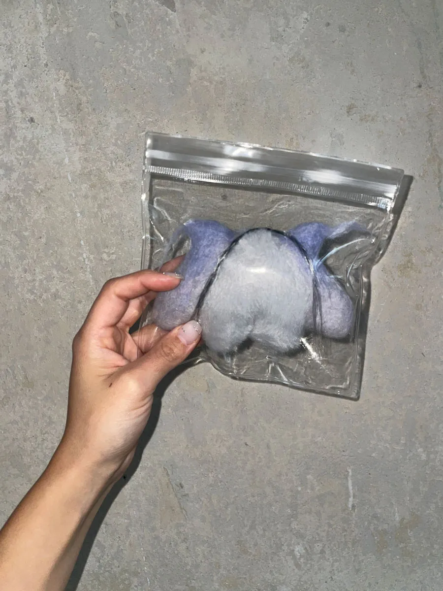 Lampi worn as accessory demonstrating its charm-like quality