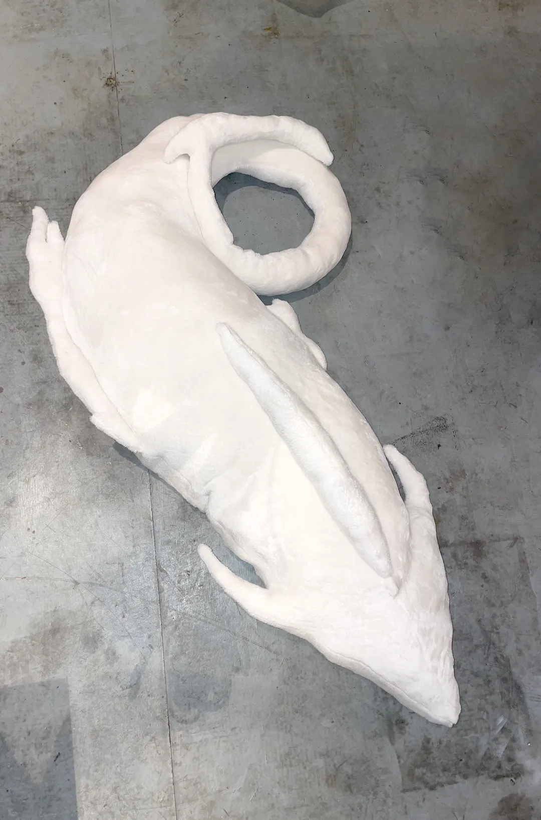 Fantastical sea creature sculpture with flowing wave-like forms in soft ocean tones