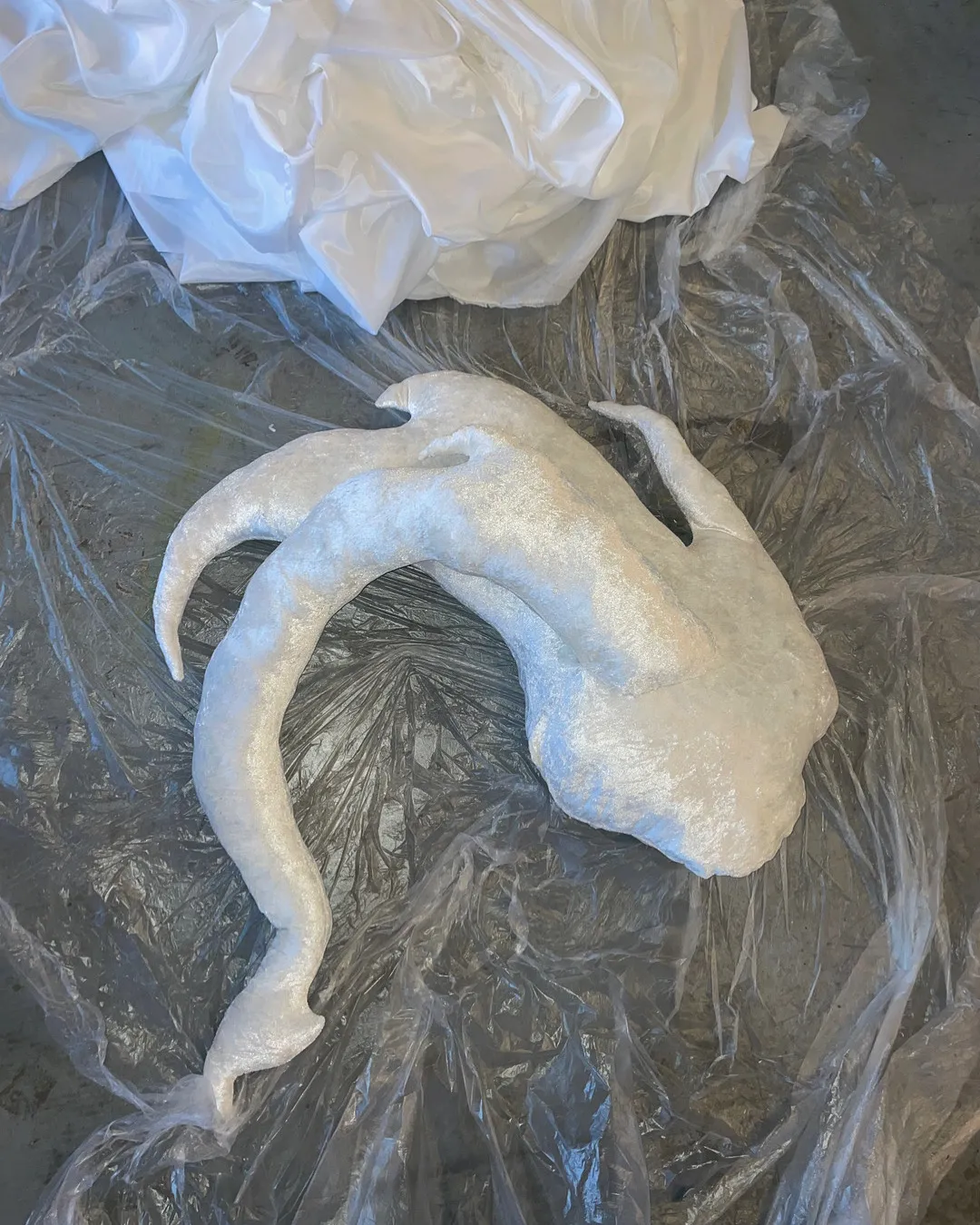 Detail view of nebula installation showing layered soft forms with projected light patterns