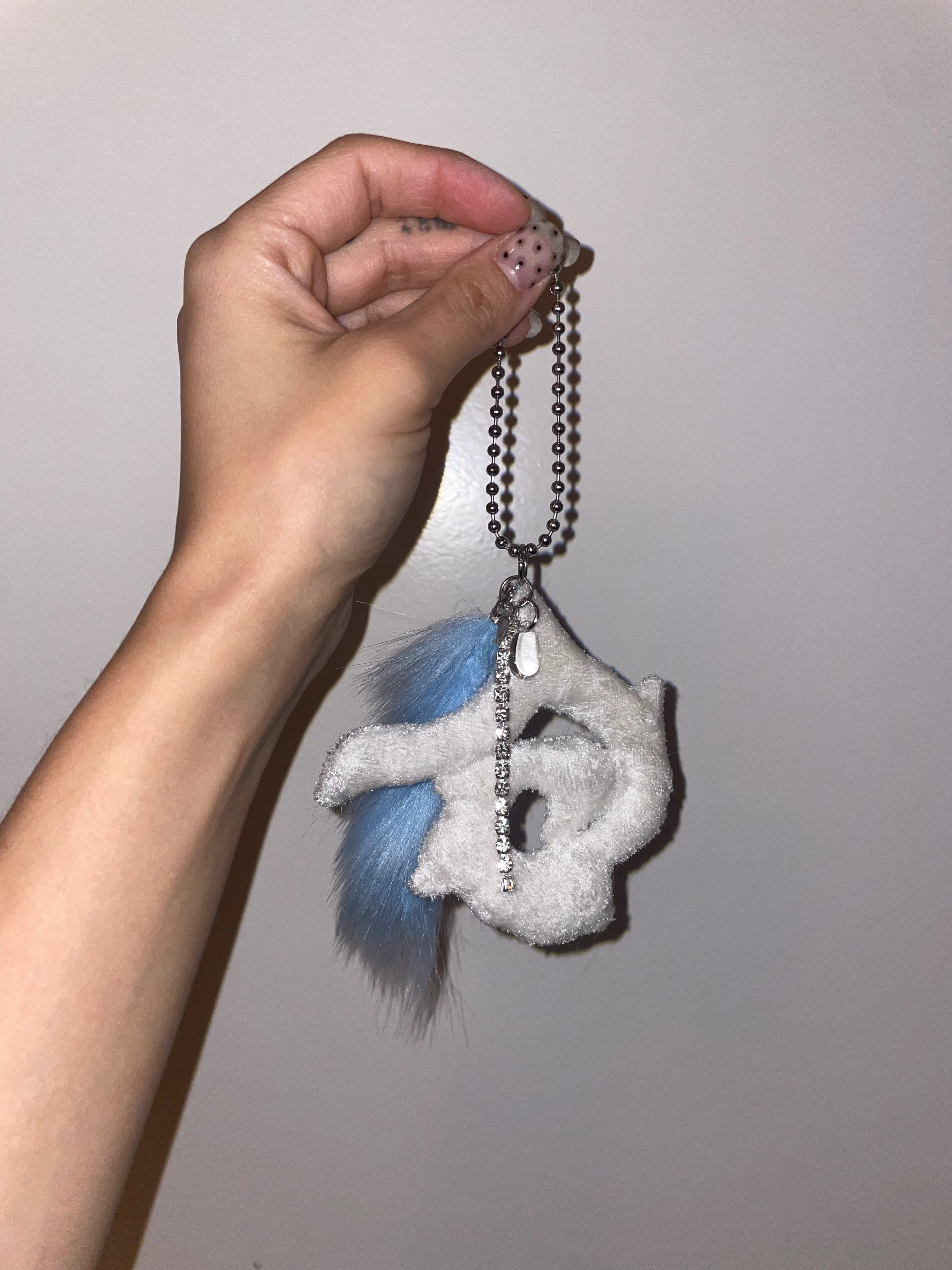 Pax creature transformed into portable keychain amulet for everyday protection